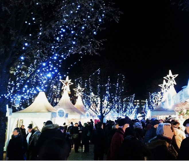 Hamburg - "Weißer Zauber" am Jungfernstieg - Weihnachtsmarkt mit weißen Pavillonzelten (beleuchteter Stern auf der Spitze) sowie blauen Lichtergirlanden in den Bäumen